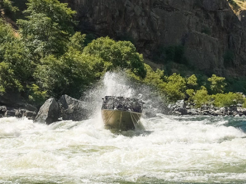 Running Hells Canyon on a jet boat tour through granite rapid